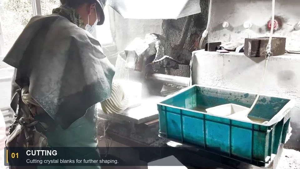 A worker cutting crystal material at a workshop station